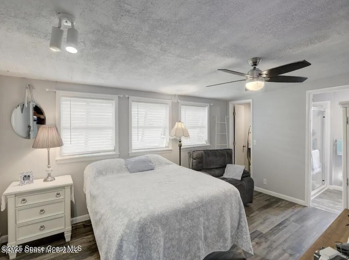 7560 Blackhawk Road Sebastian, FL 32976 - Photo 9 of 13 a spacious bedroom with a bed and a chandelier