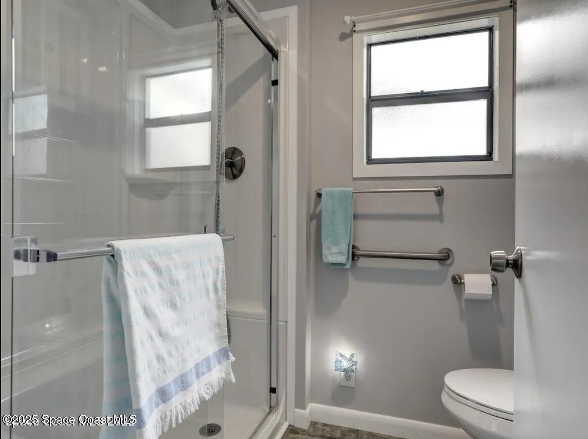 7560 Blackhawk Road Sebastian, FL 32976 - Photo 10 of 13 a bathroom with a toilet and a shower