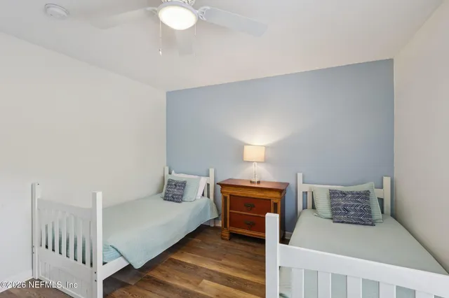 a bedroom with furniture and a wooden floor