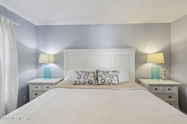 a bedroom with a bed and a night stand