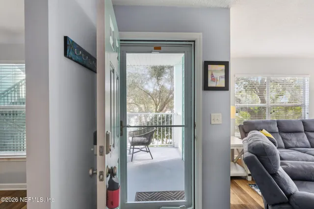 a living room with furniture and a floor to ceiling window