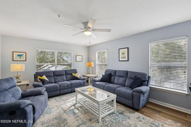 a living room with furniture a rug and a window