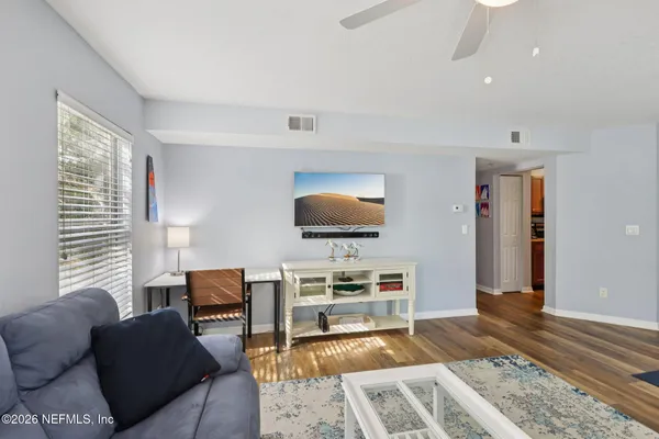 a living room with furniture and a flat screen tv