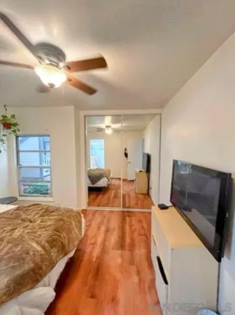 a bed room with a bed and a view of balcony