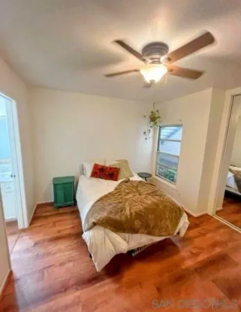 a bedroom with a bed and a mirror