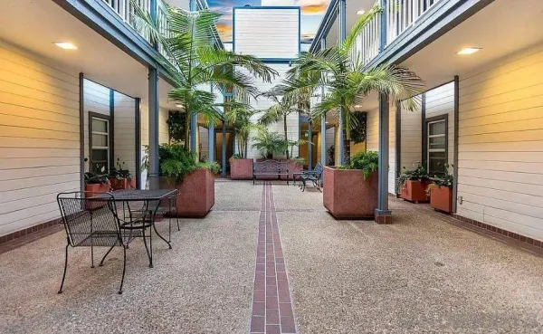 a view of a patio with table and chairs and potted plants