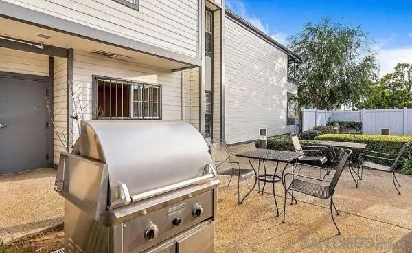 a backyard of a house with outdoor seating
