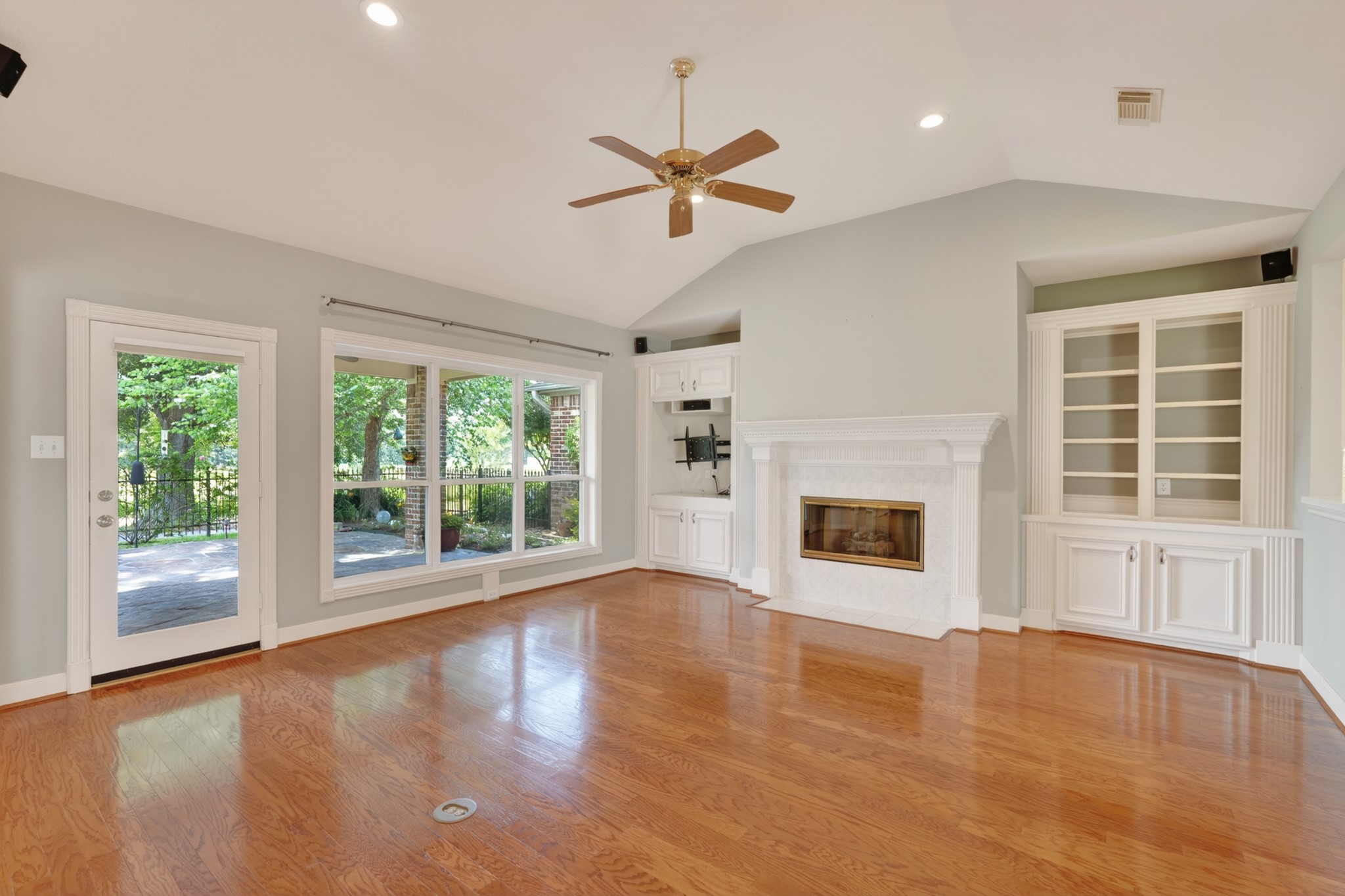 20714 Flora View Court Spring, TX 77379 - Photo 12 of 40 a view of an empty room with a window and wooden floor