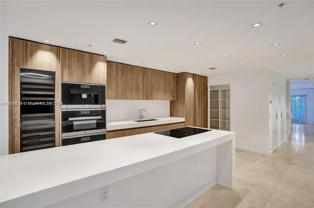 a kitchen with stainless steel appliances a refrigerator and a stove top oven