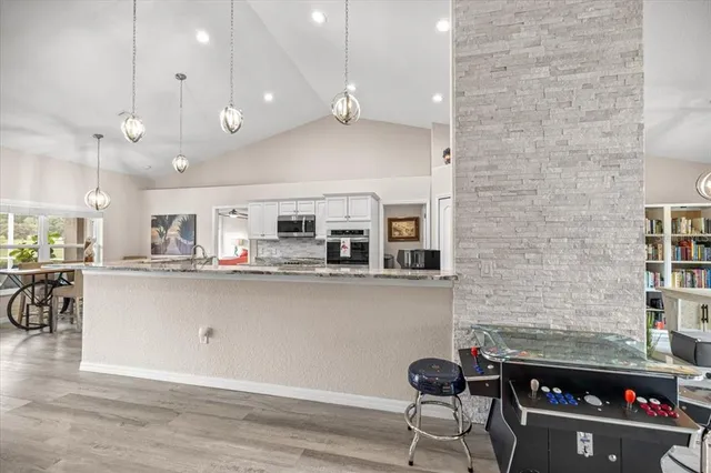 a kitchen with stainless steel appliances a refrigerator and a table