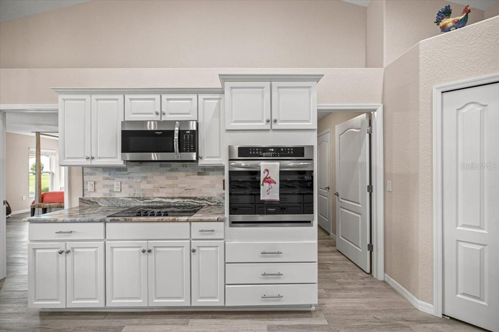 700 East Boston Street Hernando, FL 34442 - Photo 14 of 39 a kitchen with stainless steel appliances white cabinets and a refrigerator