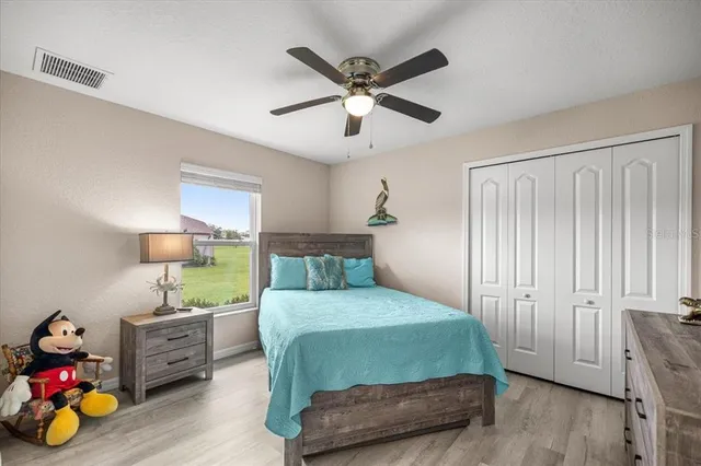 a bedroom with furniture and a wooden floor