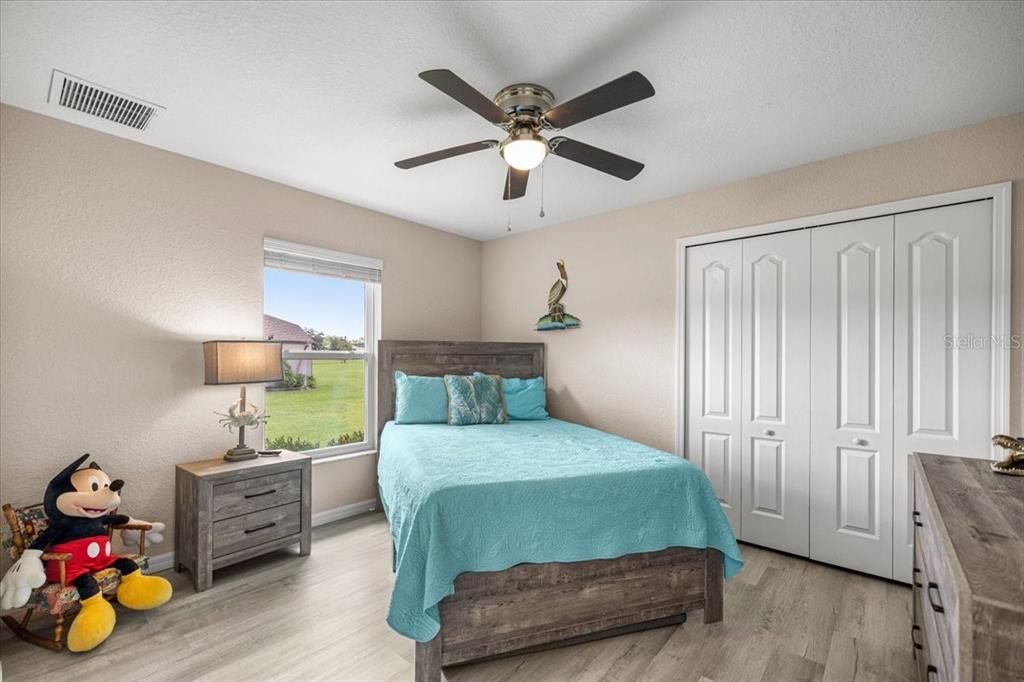 700 East Boston Street Hernando, FL 34442 - Photo 22 of 40 a bedroom with furniture and a wooden floor