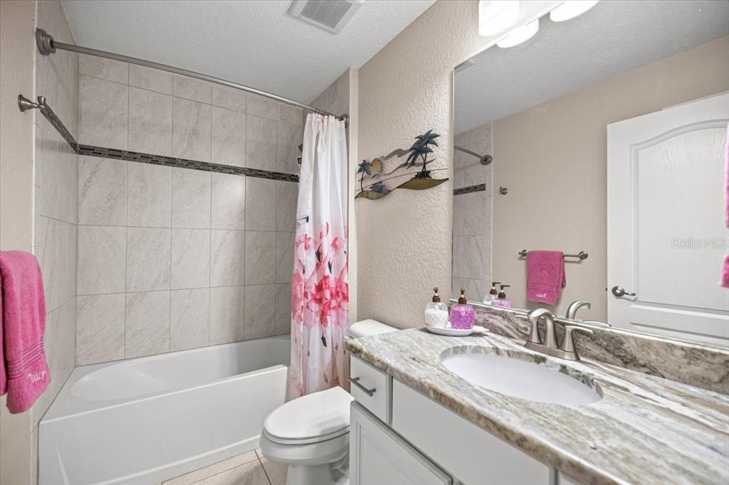 700 East Boston Street Hernando, FL 34442 - Photo 24 of 40 a bathroom with a granite countertop sink a toilet and shower