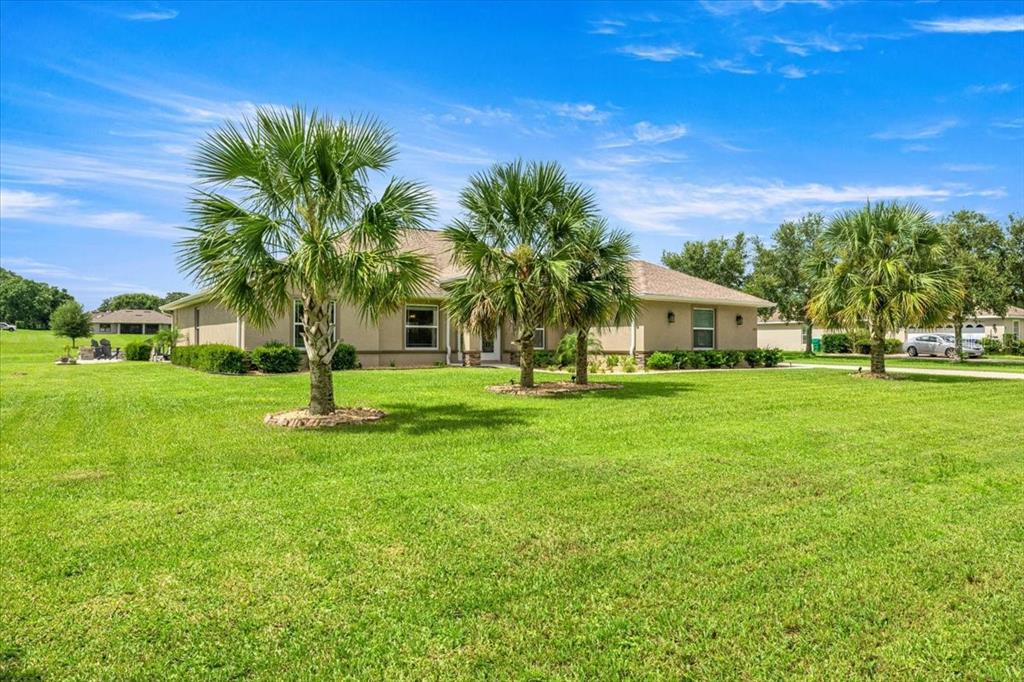 700 East Boston Street Hernando, FL 34442 - Photo 32 of 39 a front view of a house with garden and tree