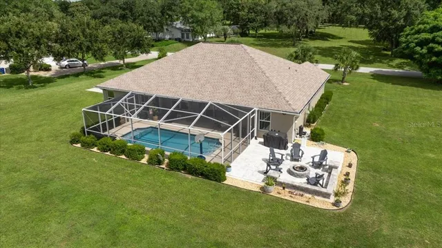 a view of a backyard with sitting area and garden
