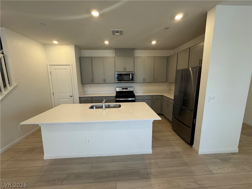 2821 Alcobaca Street Henderson, NV 89044 - Photo 4 of 24 A spacious kitchen with a large island and ample cabinet storage offers seamless culinary possibilities.