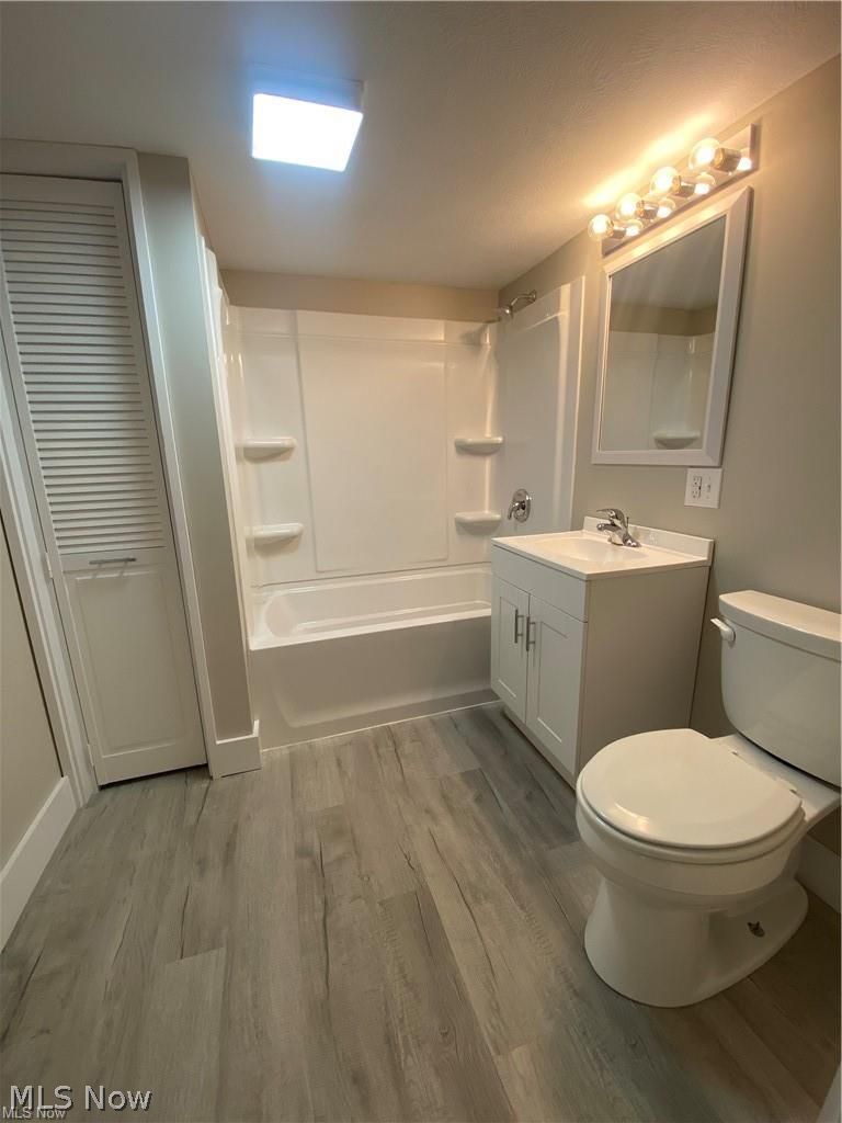 2803 State Road Vermilion, OH 44089 - Photo 14 of 28 Brand new Full bathroom featuring vanity, bathing tub / shower combination, and light wood-style floors.