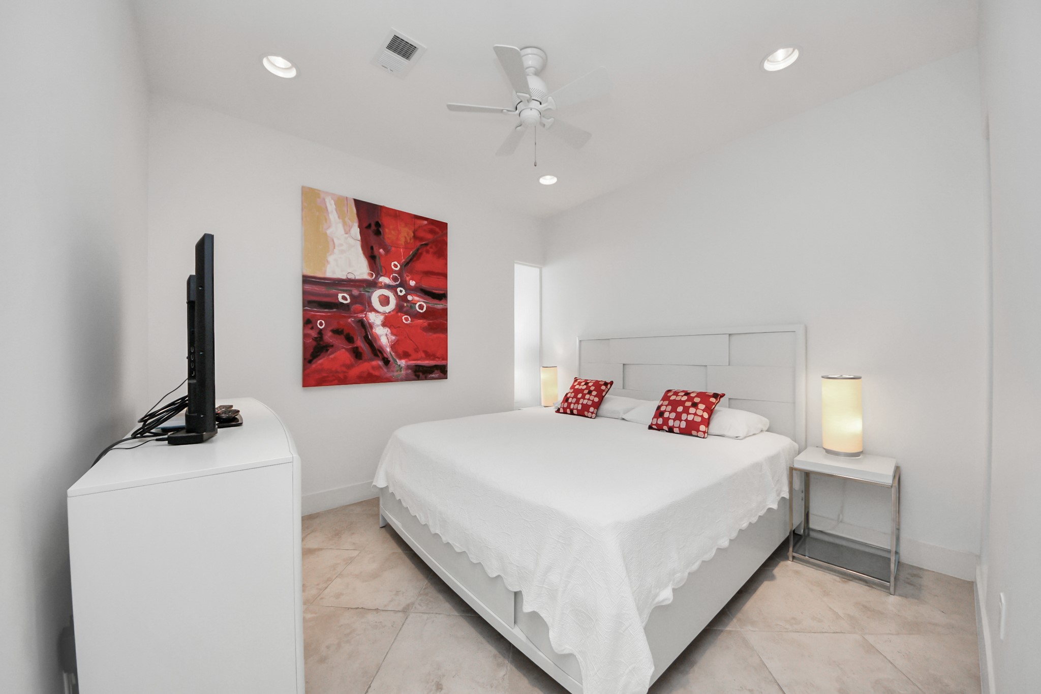 10327 Termini-San Luis Pass Road, Unit 617 Galveston, TX 77554 - Photo 16 of 50 a bedroom with a bed and a flat screen tv