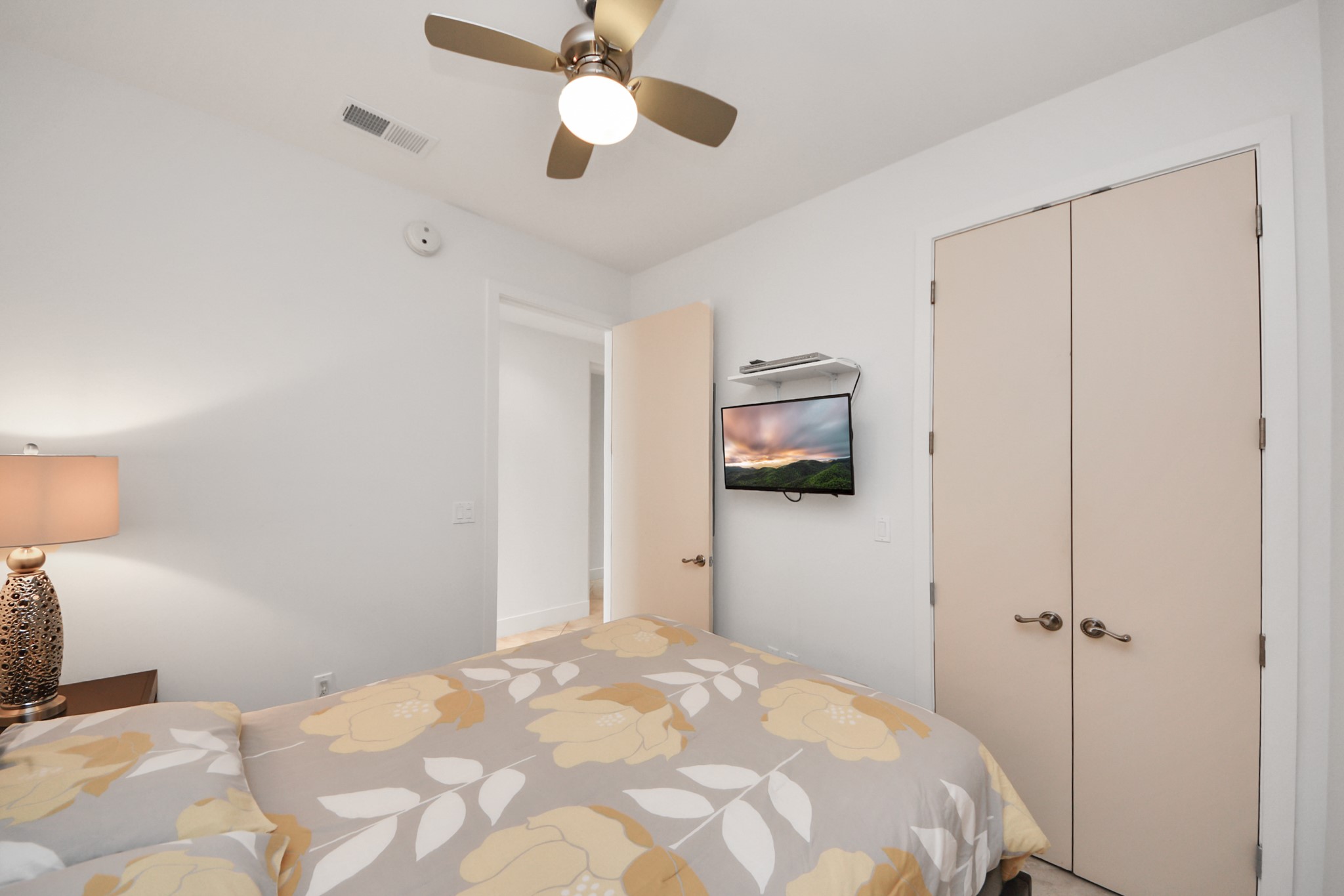 10327 Termini-San Luis Pass Road, Unit 617 Galveston, TX 77554 - Photo 30 of 50 a bedroom with a bed and a flat tv screen