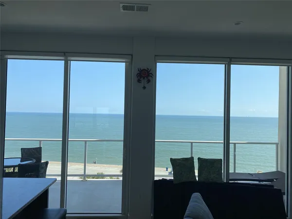 a kitchen with a table chairs refrigerator and microwave