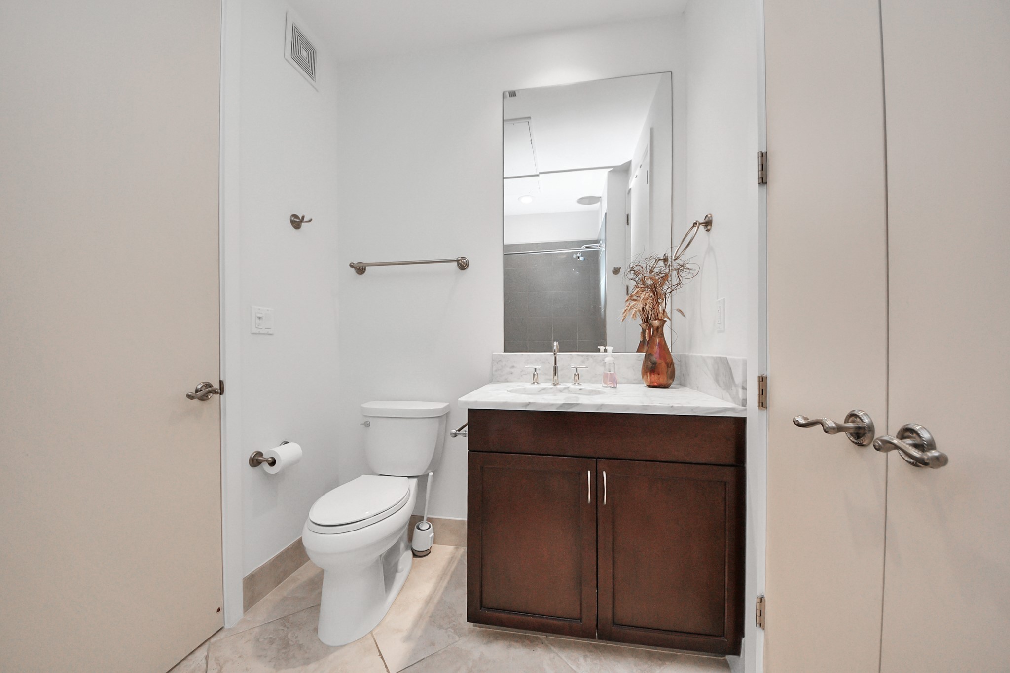 10327 Termini-San Luis Pass Road, Unit 617 Galveston, TX 77554 - Photo 33 of 50 a bathroom with a toilet sink and mirror