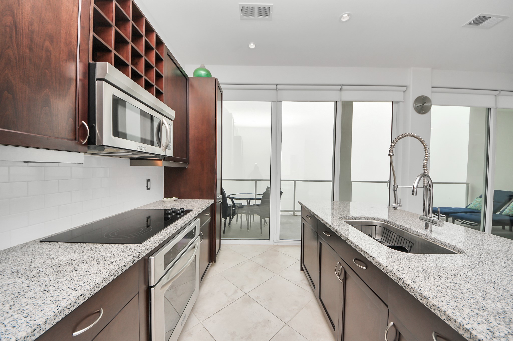 10327 Termini-San Luis Pass Road, Unit 617 Galveston, TX 77554 - Photo 7 of 50 a kitchen with granite countertop a sink and a stove