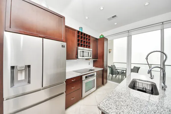 a kitchen with granite countertop a sink and a stove