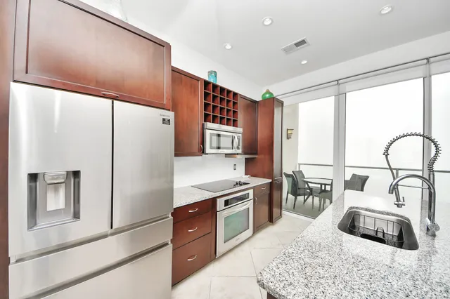 a kitchen with granite countertop a sink and a stove