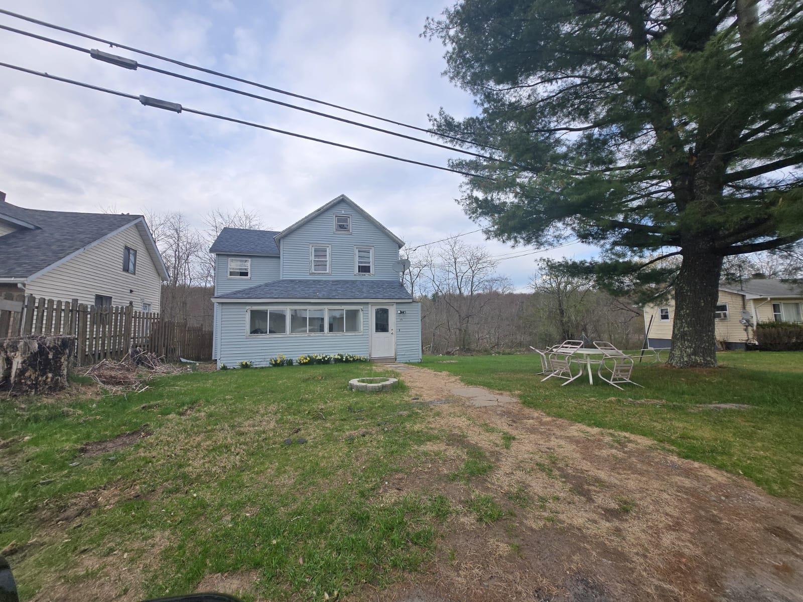 89 Cold Spring Road Monticello, NY 12701 - Photo 3 of 3 a view of house with a big yard and large tree