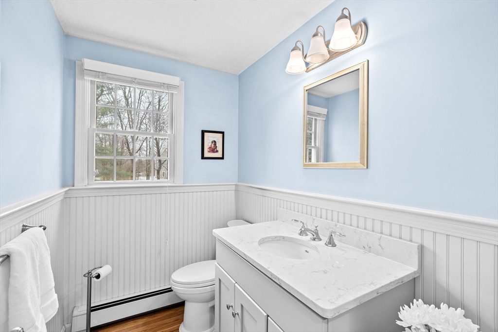 9 Windward Lane Scituate, MA 02066 - Photo 15 of 37 a bathroom with a sink a toilet a mirror and a window
