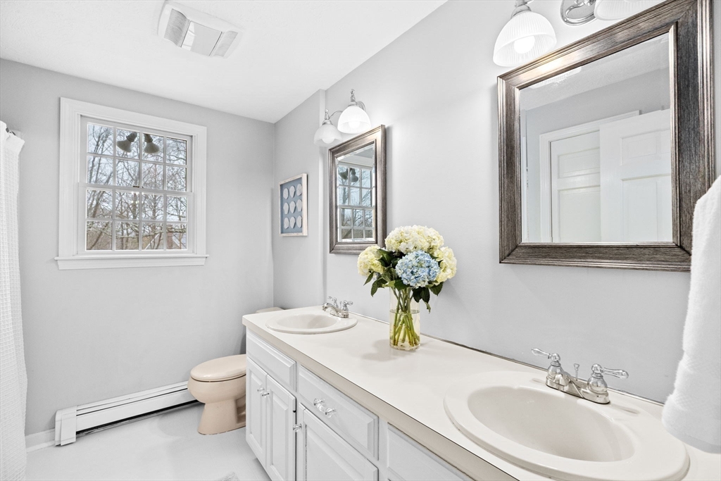 9 Windward Lane Scituate, MA 02066 - Photo 17 of 37 a bathroom with a toilet a sink and mirror