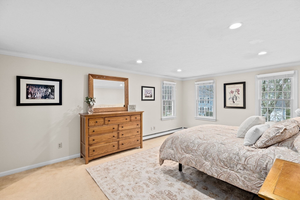 9 Windward Lane Scituate, MA 02066 - Photo 20 of 37 a bedroom with a bed and a dresser