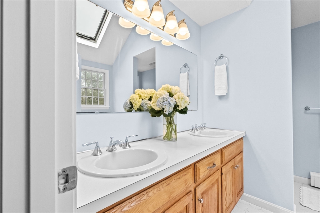 9 Windward Lane Scituate, MA 02066 - Photo 21 of 37 a bathroom with a sink a large mirror and a window