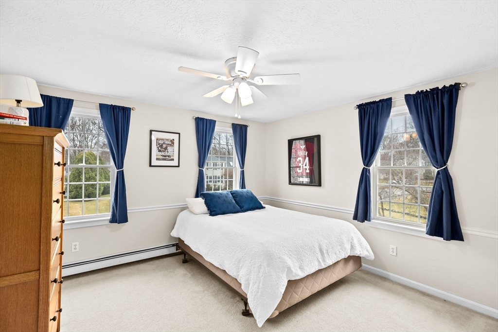 9 Windward Lane Scituate, MA 02066 - Photo 22 of 37 a bedroom with a bed and a flat tv screen