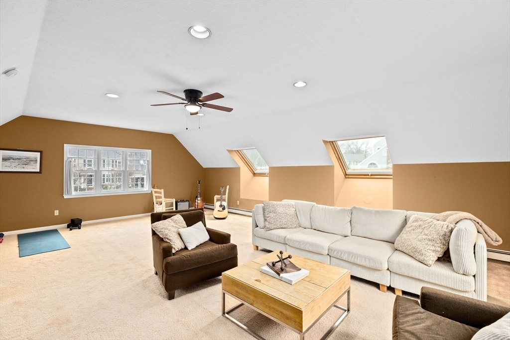 9 Windward Lane Scituate, MA 02066 - Photo 23 of 37 a living room with furniture and a chandelier