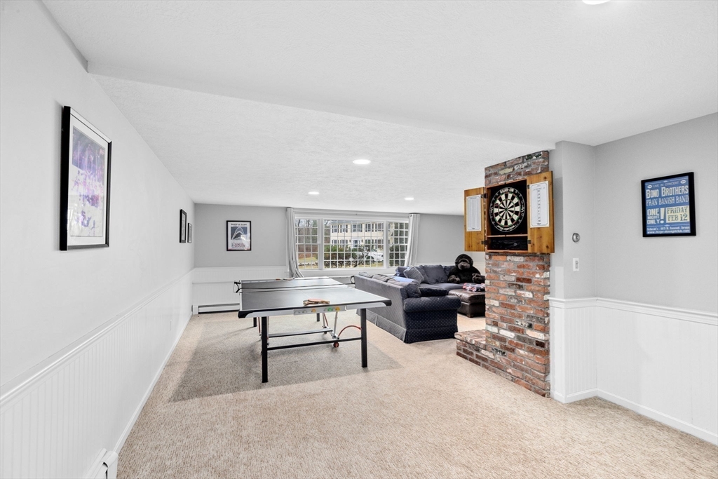 9 Windward Lane Scituate, MA 02066 - Photo 26 of 37 a living room with furniture and a flat screen tv