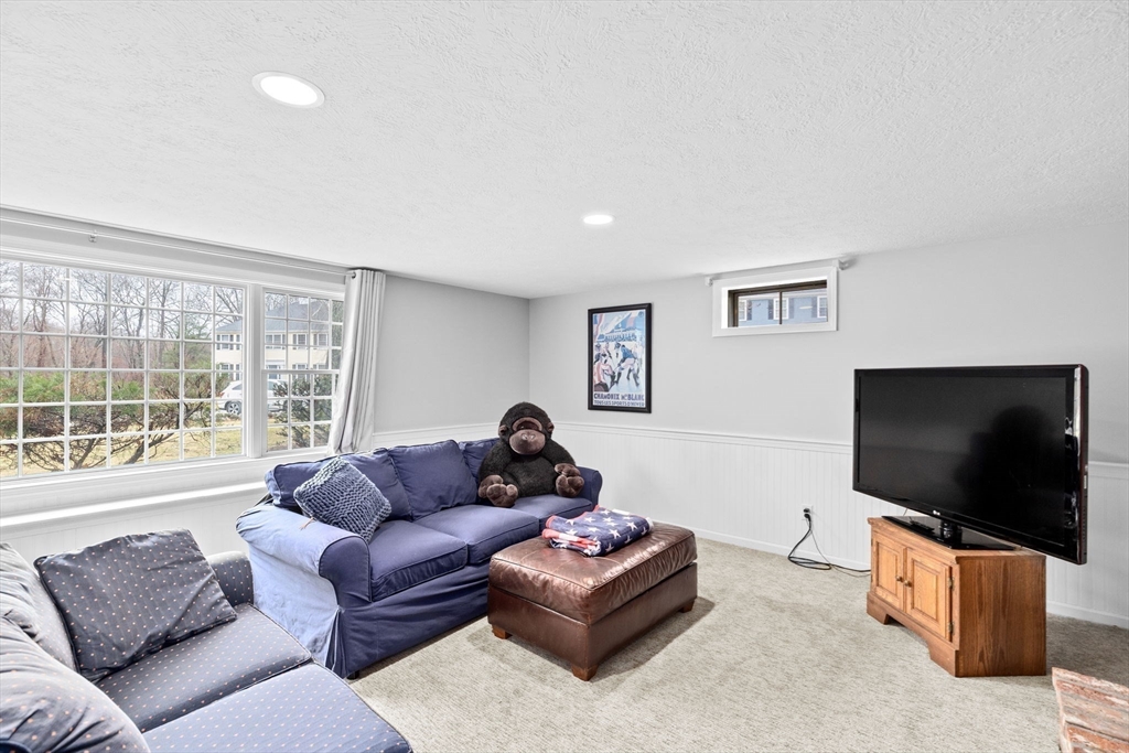 9 Windward Lane Scituate, MA 02066 - Photo 27 of 37 a living room with furniture and a flat screen tv