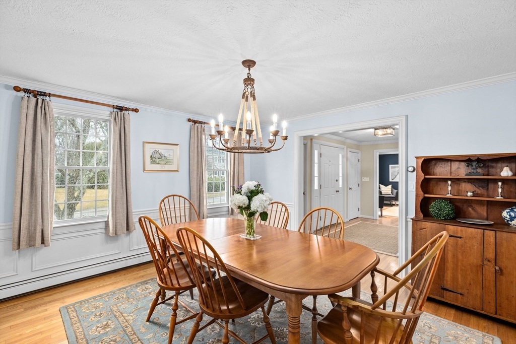 9 Windward Lane Scituate, MA 02066 - Photo 4 of 37 a view of a dining room with furniture window and wooden floor