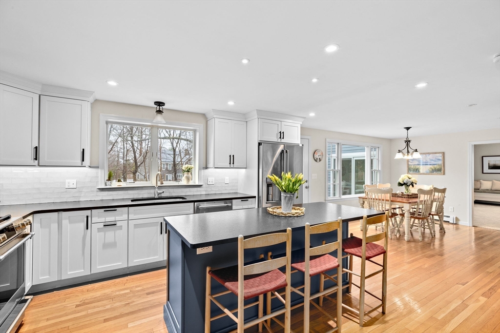 9 Windward Lane Scituate, MA 02066 - Photo 5 of 37 a kitchen with stainless steel appliances granite countertop a table and chairs in it