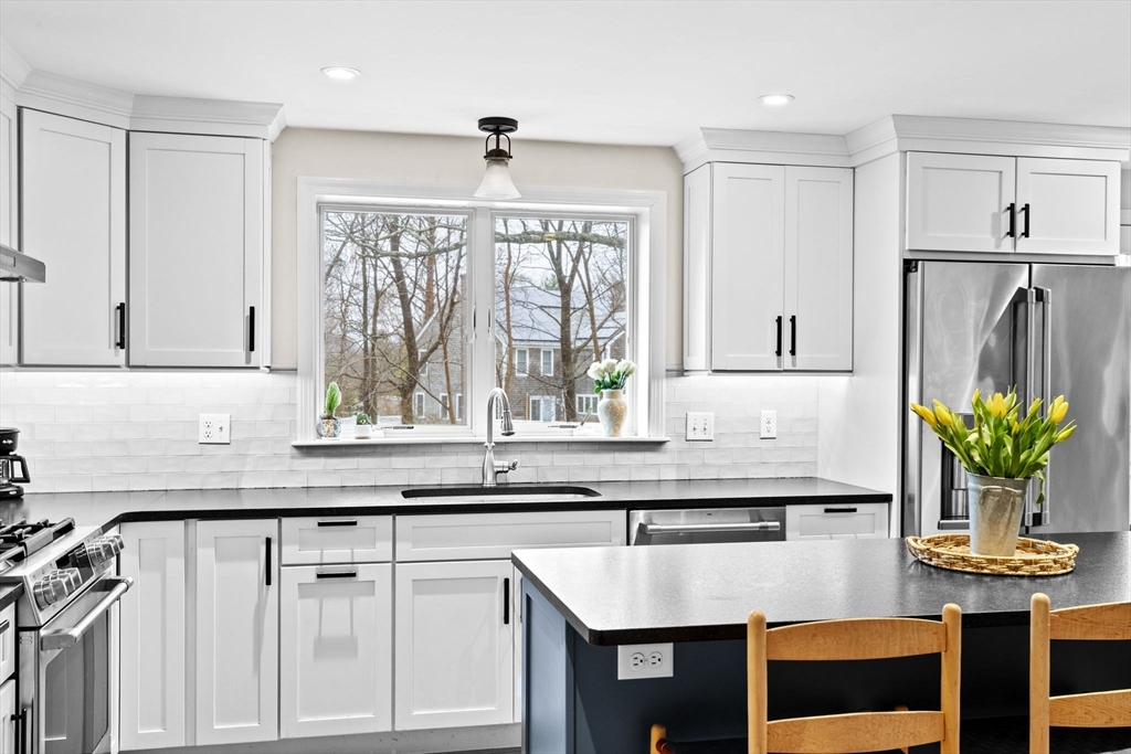 9 Windward Lane Scituate, MA 02066 - Photo 7 of 37 a kitchen with stainless steel appliances granite countertop a stove a sink and a microwave