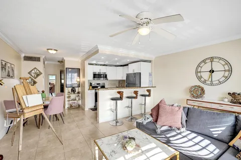 a living room with furniture a window and kitchen view