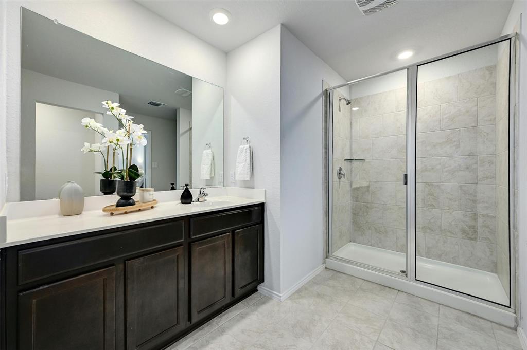 1045 Taggart Trail Jarrell, TX 76537 - Photo 11 of 19 Full bathroom featuring a stall shower, vanity, light tile patterned floors, and recessed lighting
