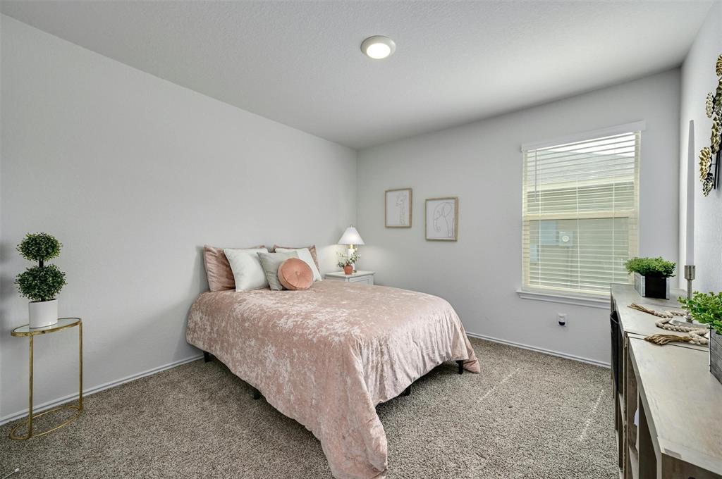 1045 Taggart Trail Jarrell, TX 76537 - Photo 12 of 19 Bedroom featuring carpet floors and baseboards