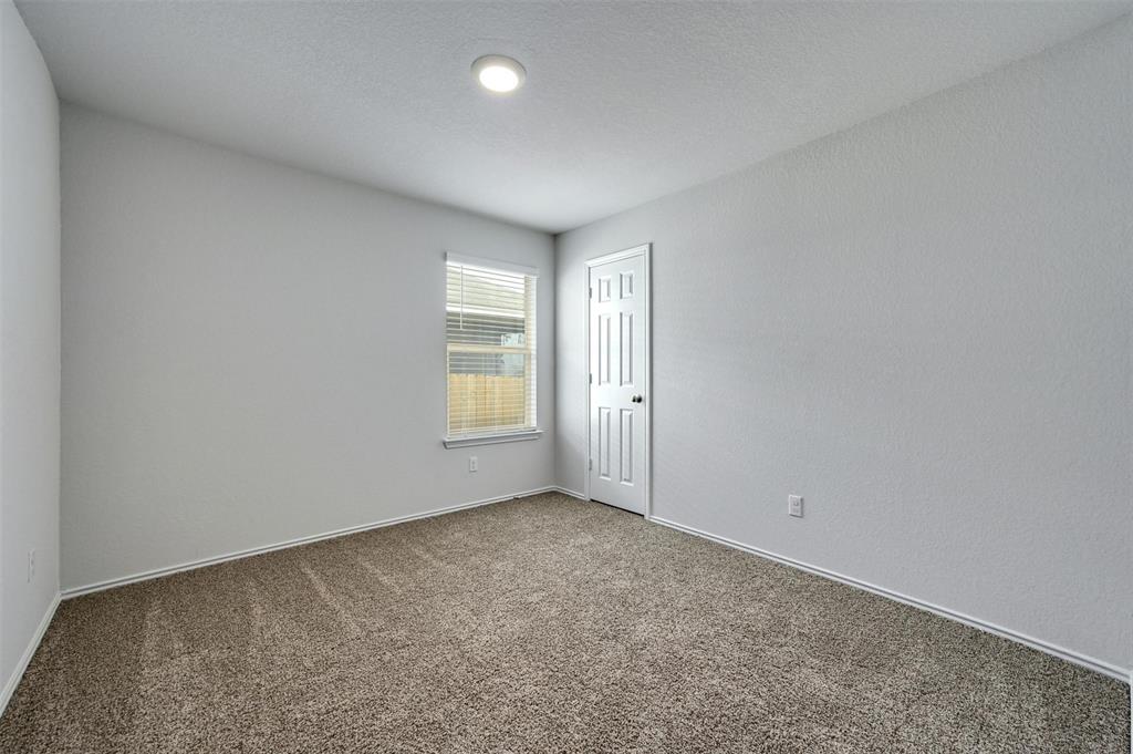 1045 Taggart Trail Jarrell, TX 76537 - Photo 15 of 19 Carpeted empty room with baseboards