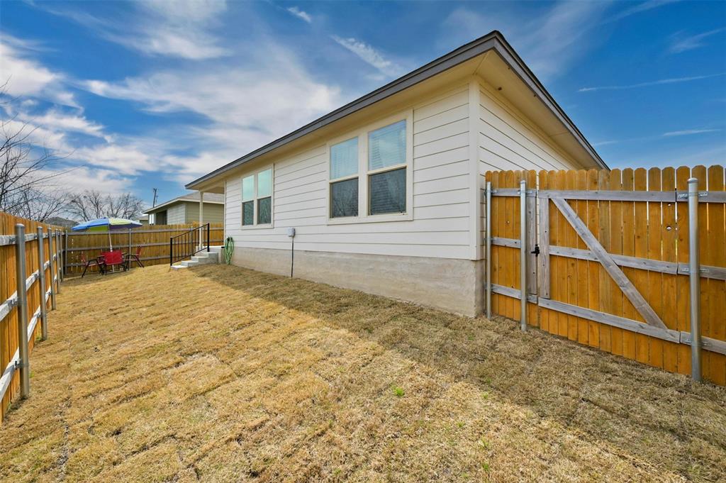 1045 Taggart Trail Jarrell, TX 76537 - Photo 19 of 19 View of side of home featuring a fenced backyard and a gate