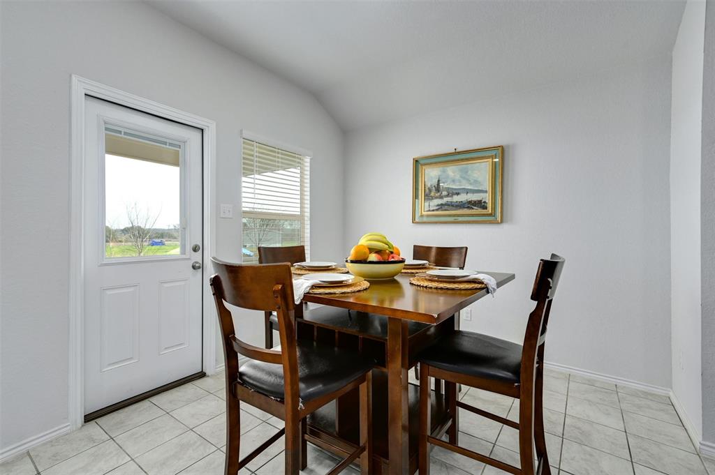 1045 Taggart Trail Jarrell, TX 76537 - Photo 6 of 19 Dining area featuring light tile patterned flooring and vaulted ceiling