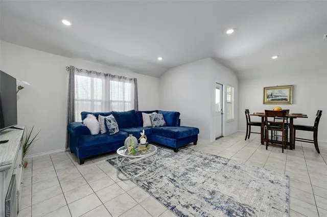a living room with furniture and kitchen view