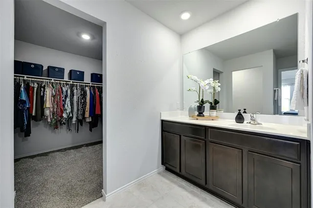 a bathroom with a double vanity sink mirror and shower