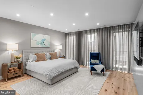a bedroom with a large bed and a large window